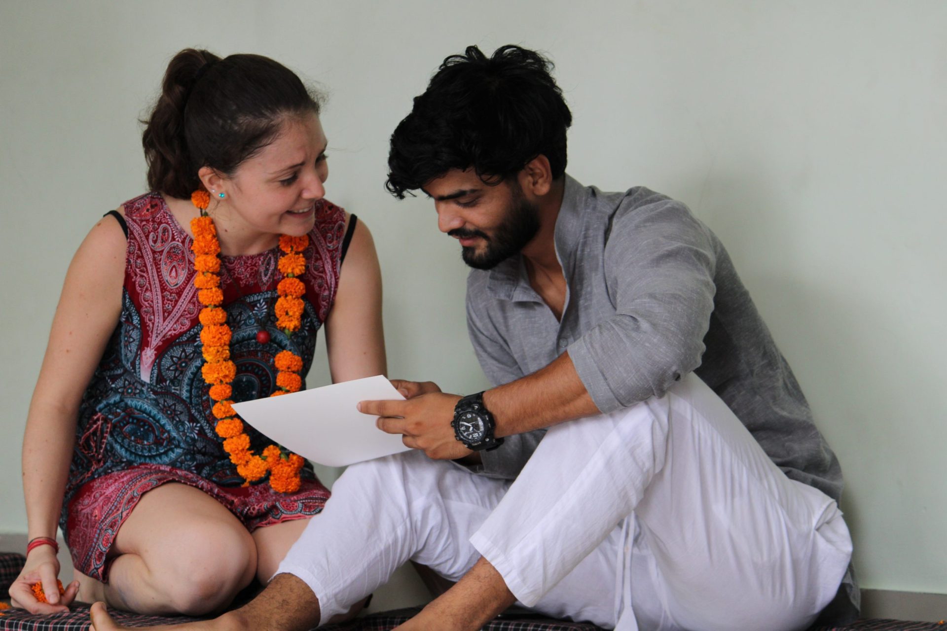 Student attentively listening and learning from yoga teacher during theory class at Sage House Yoga