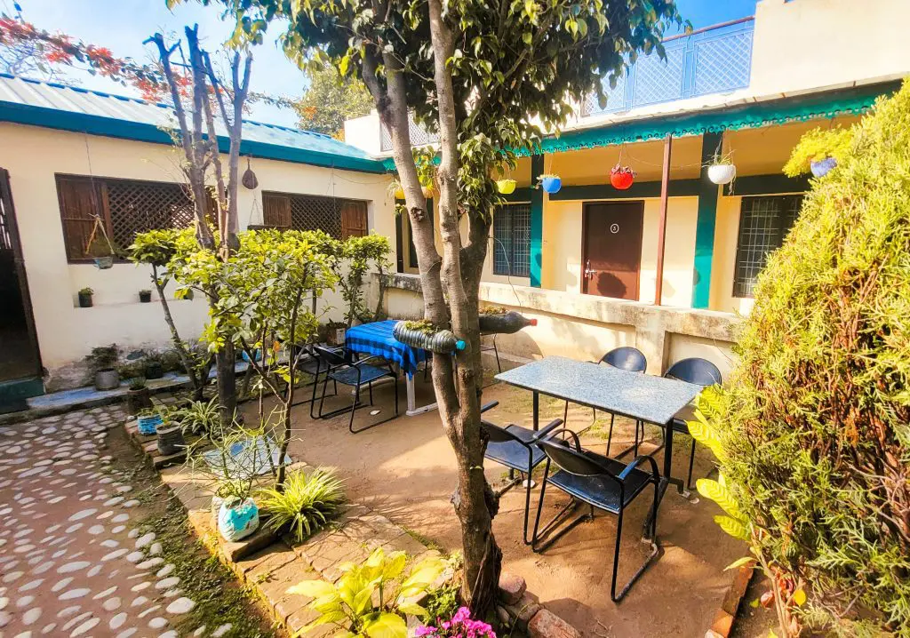 Relaxing ambiance at the retreat center cafeteria: The spacious and inviting cafeteria at Sage House Yoga's retreat center offers a serene setting with large windows that showcase a panoramic view of surrounding nature, creating a delightful atmosphere for guests to enjoy their meals and connect with the tranquility of the surroundings.