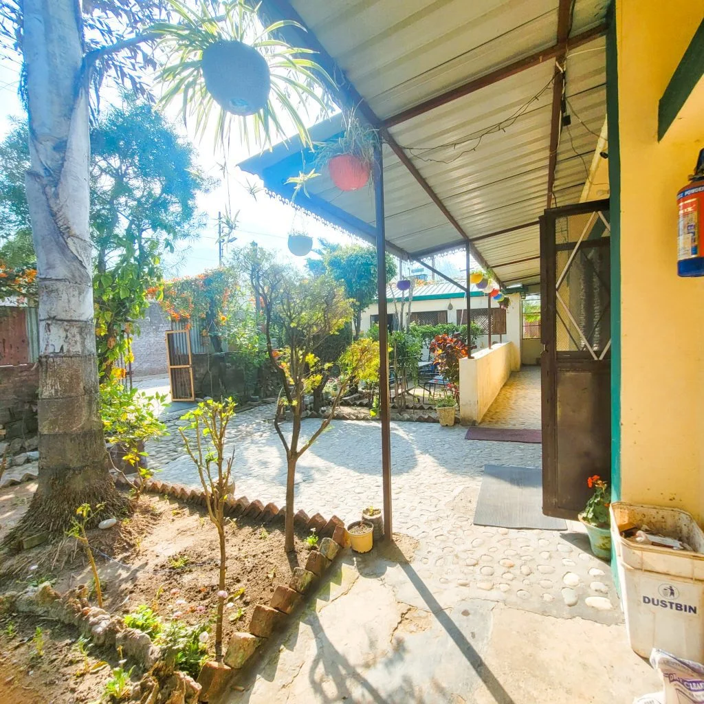 Refreshing view from the rooms: Guests at Sage House Yoga's retreat center are greeted with a soothing sight of a lush green lawn stretching out from their windows, providing a peaceful and rejuvenating ambiance, inviting them to connect with nature during their stay.