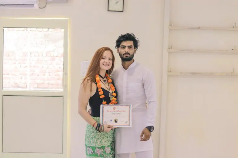 Student laughing with joy and bliss during closing ceremony at Sage House Yoga