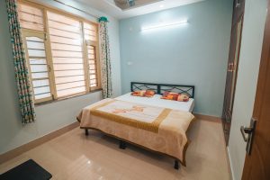 Comfort and serenity in Rishikesh: Cozy rooms at Sage House Yoga provide a peaceful retreat, featuring relaxing decor, comfortable furnishings, and a tranquil ambiance for a rejuvenating stay.