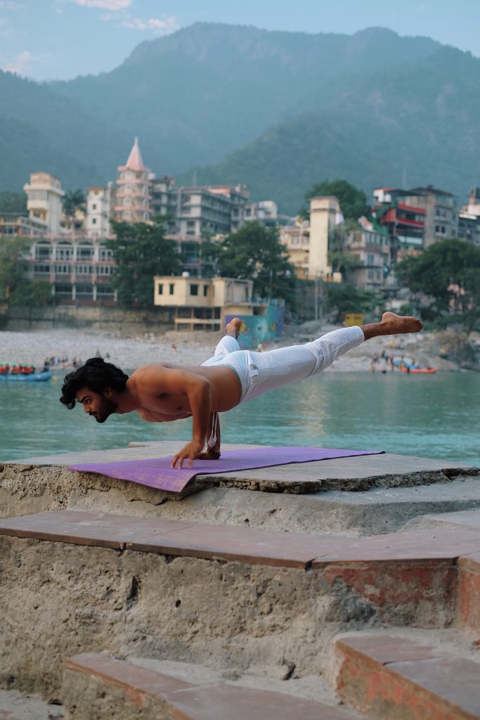 men performing yoga at near ganga river