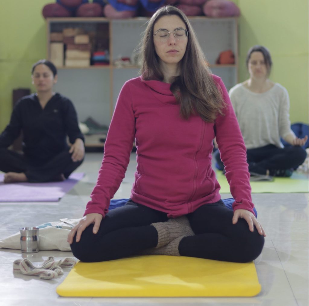 Deepening mindfulness at Sage House Yoga: Students cultivate focus and attention with closed eyes, immersing themselves in the present moment during the transformative yoga class.