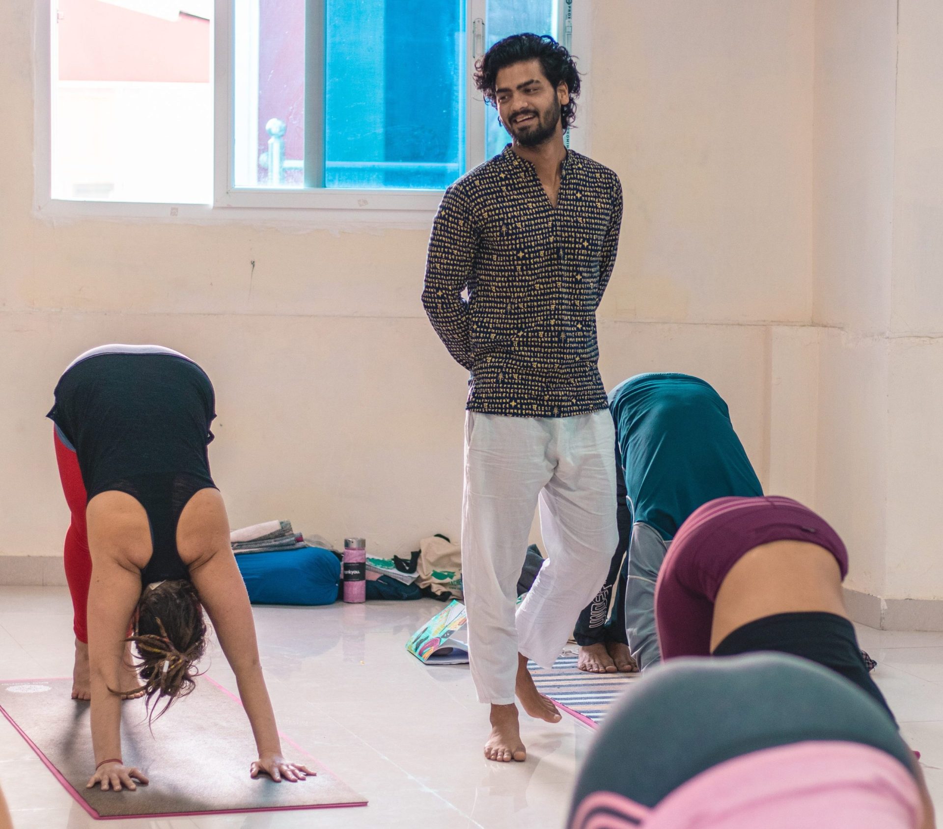Guided wisdom at Sage House Yoga: Yogi Ankit, a knowledgeable instructor, passionately briefs students, sharing insights and teachings during the yoga class.