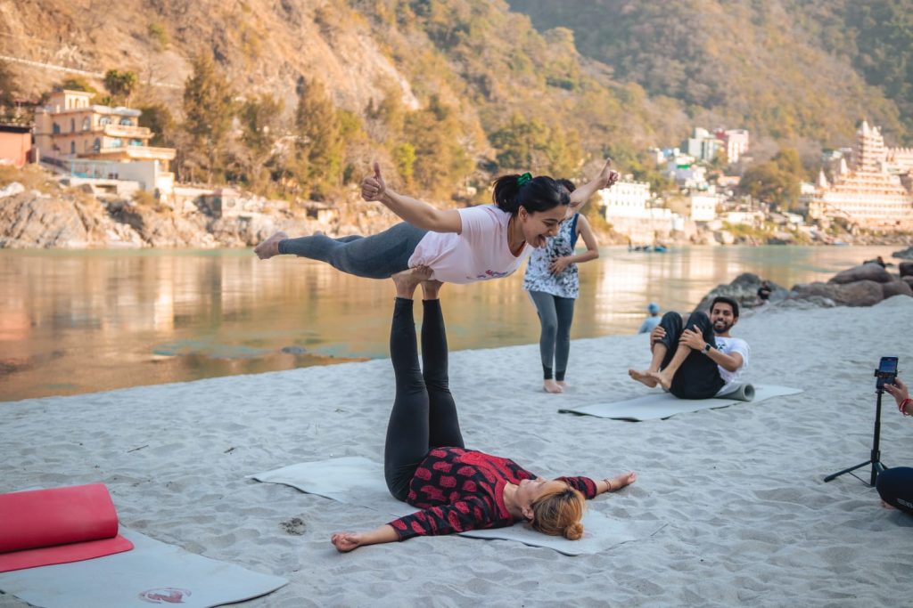 Female performing acro yoga at sage house yoga near ganges in rishikesh