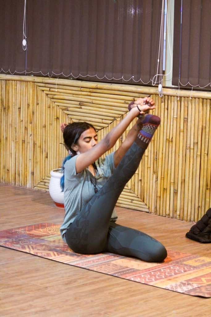 Girl doing boat pose at Sage House Yoga, Rishikesh