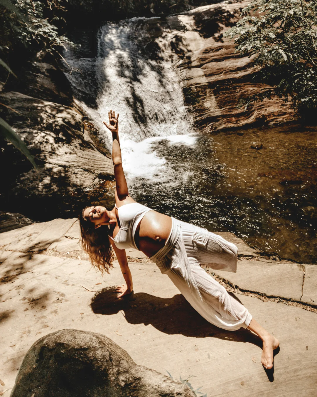 Woman Performing Prenatal Yoga Pose Near Waterfall | Sage House Yoga, Rishikesh