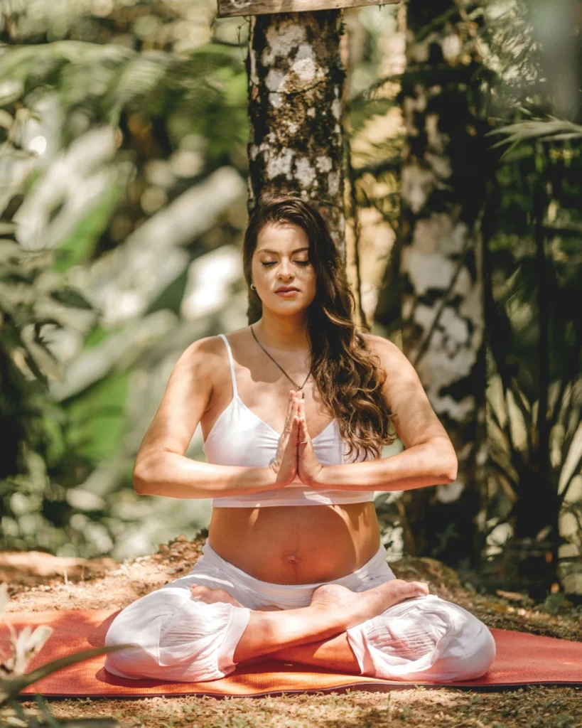 Woman Sitting in a Meditative Mudra in Rishikesh | Sage House Yoga