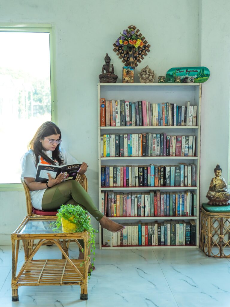 Woman Reading Yoga Book at Sage House Yoga | Rishikesh